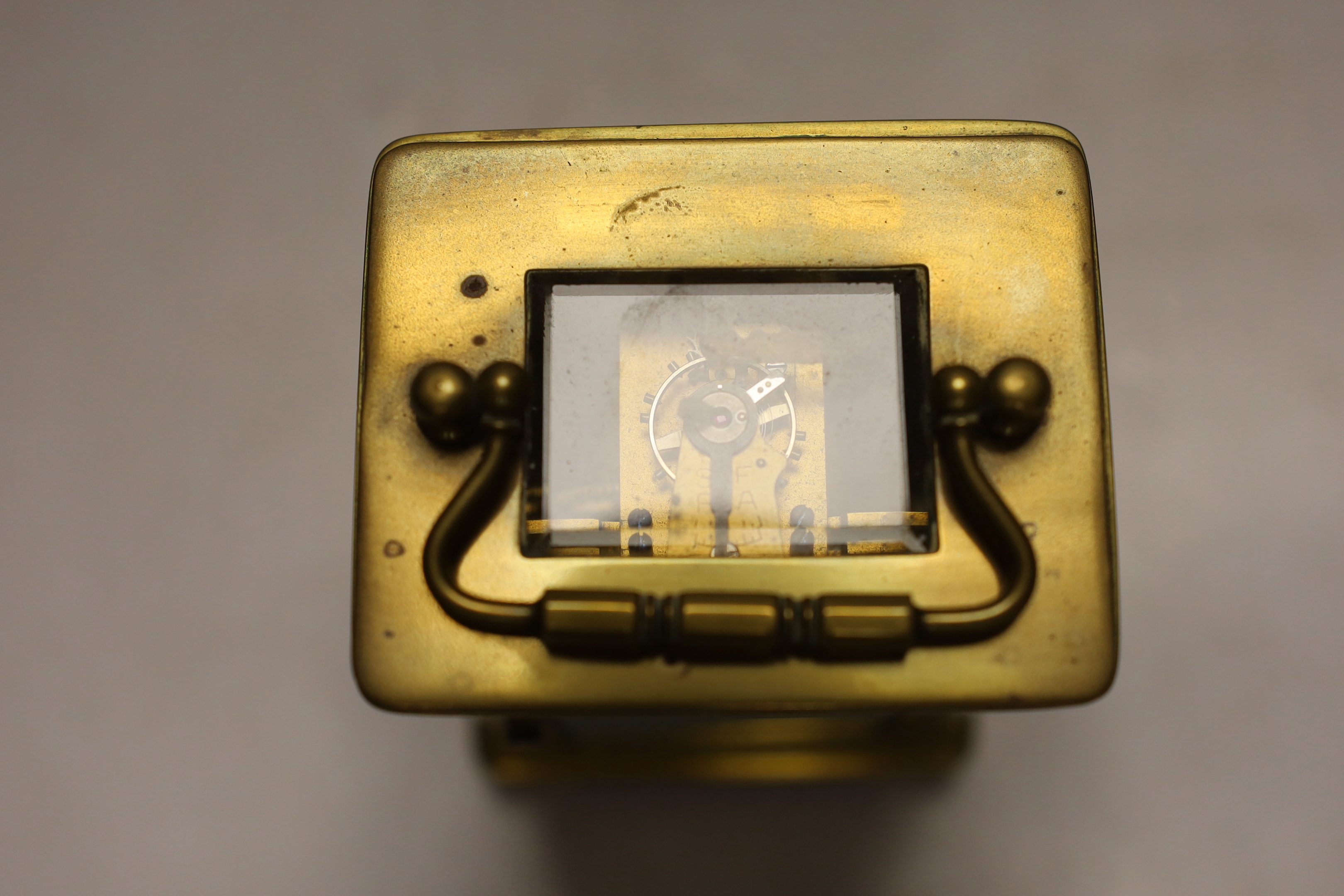 An early 20th century French lacquered brass carriage clock, cased